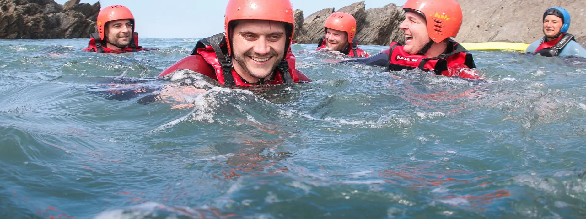 Coasteering group swimming together off the North Devon coast